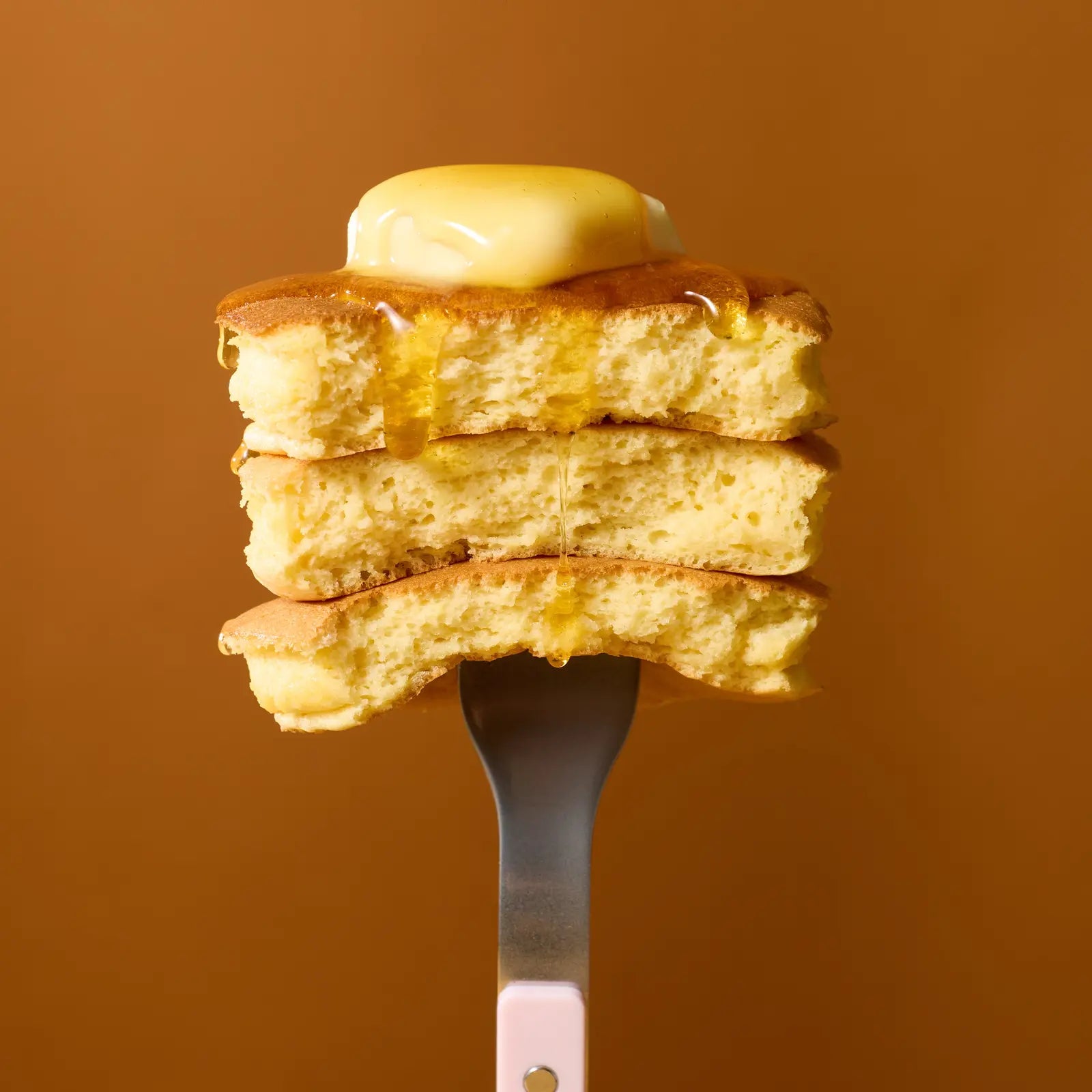 A forkful of mochi pancakes with melting butter